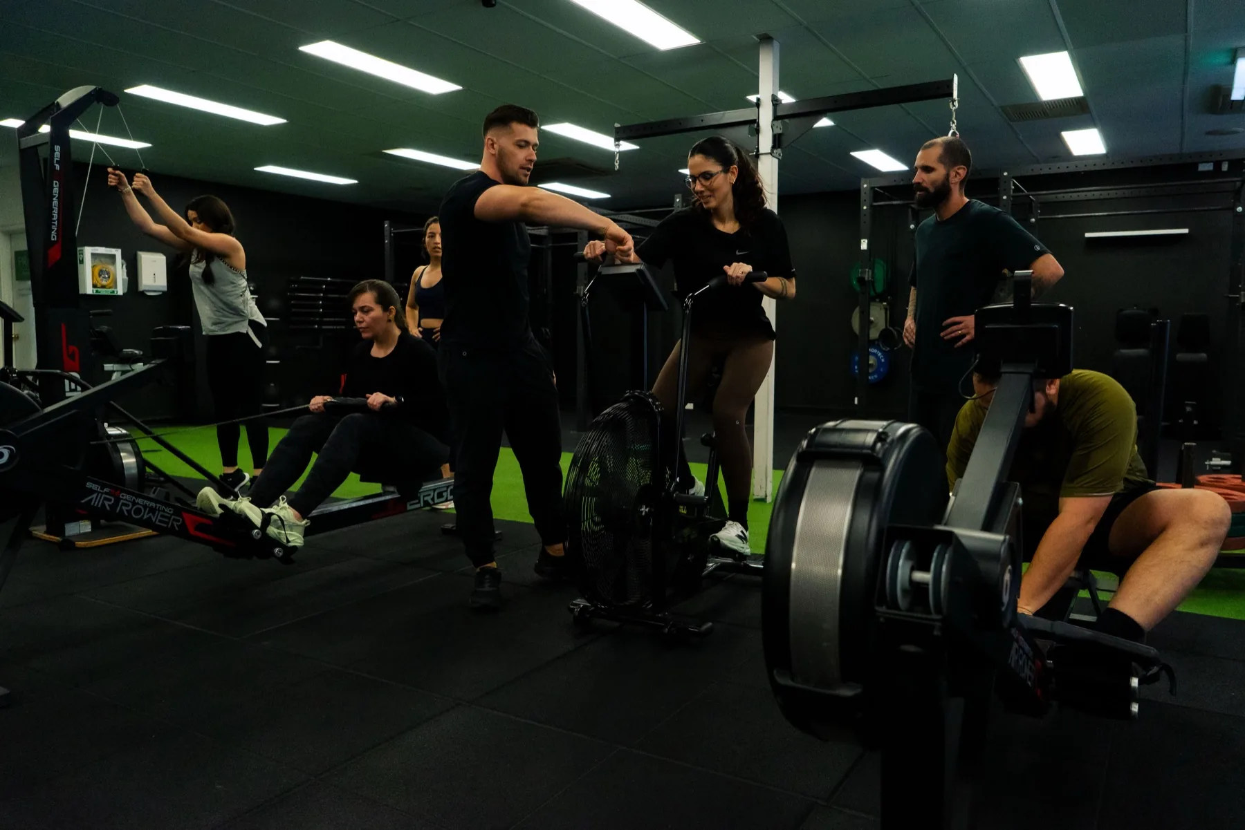 Small group rotating through rowing and cardio equipment