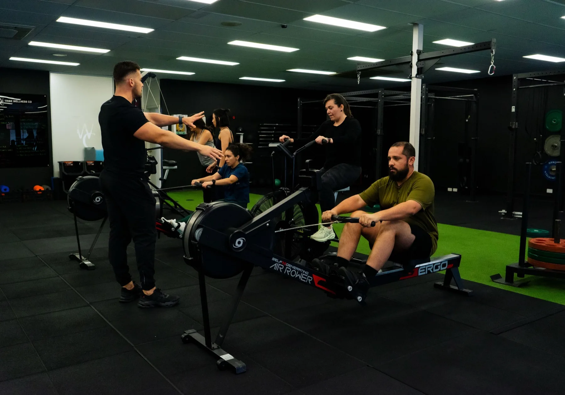 Hudson coaching multiple clients across rowing stations