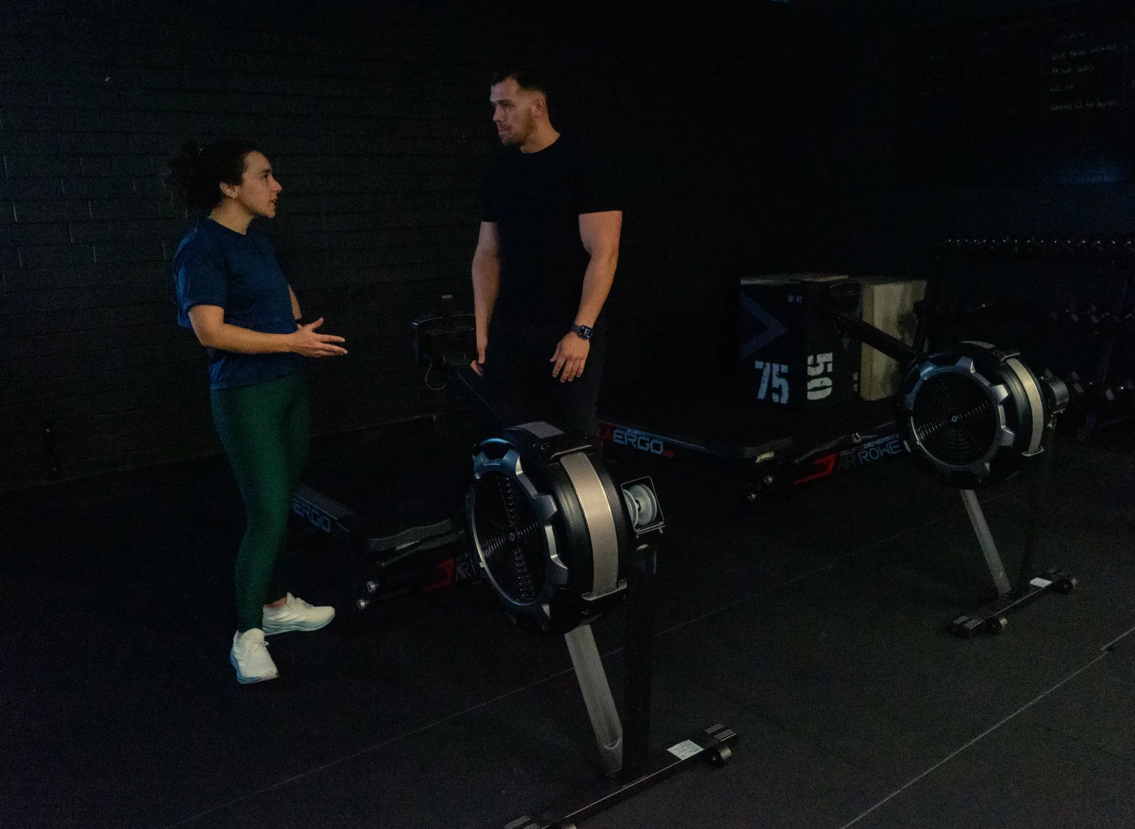 Hudson discussing technique with a client in the gym