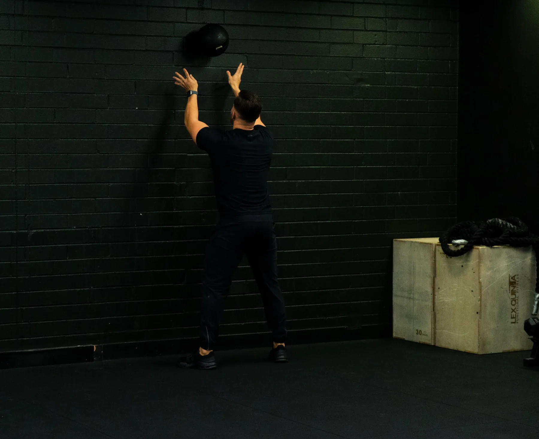 Hudson performing a wall ball toss in the gym