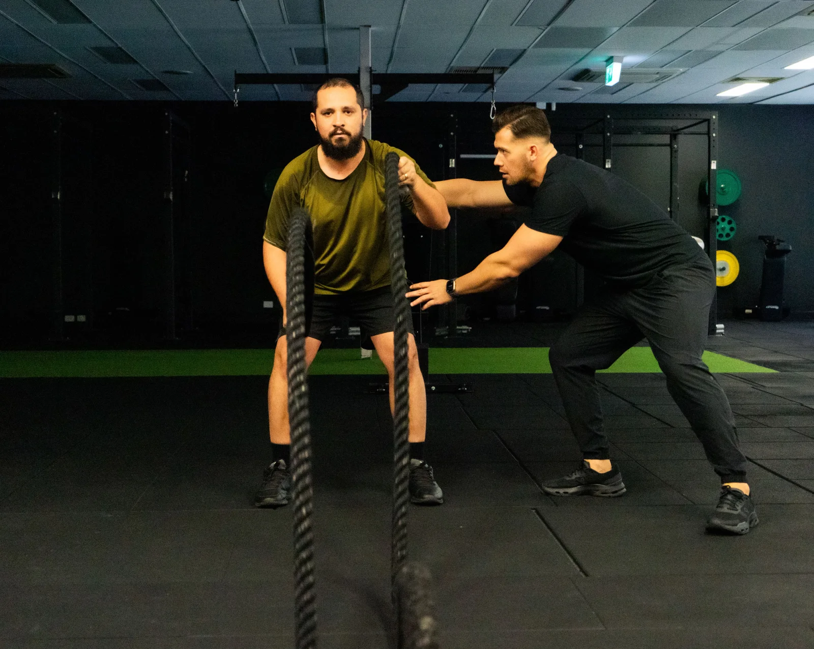Hudson supporting a client during strength training