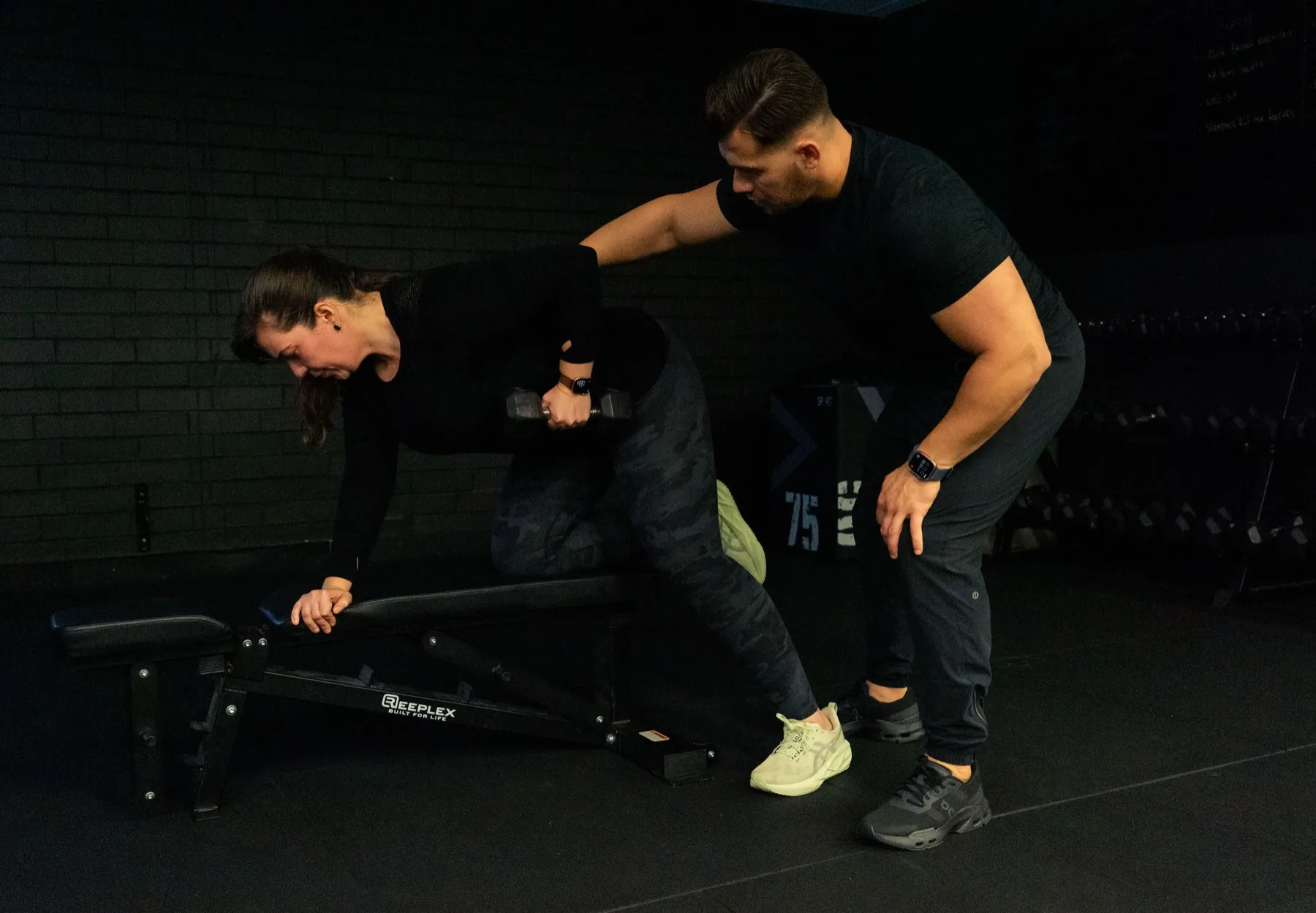 Hudson cueing a client during a one-arm dumbbell row