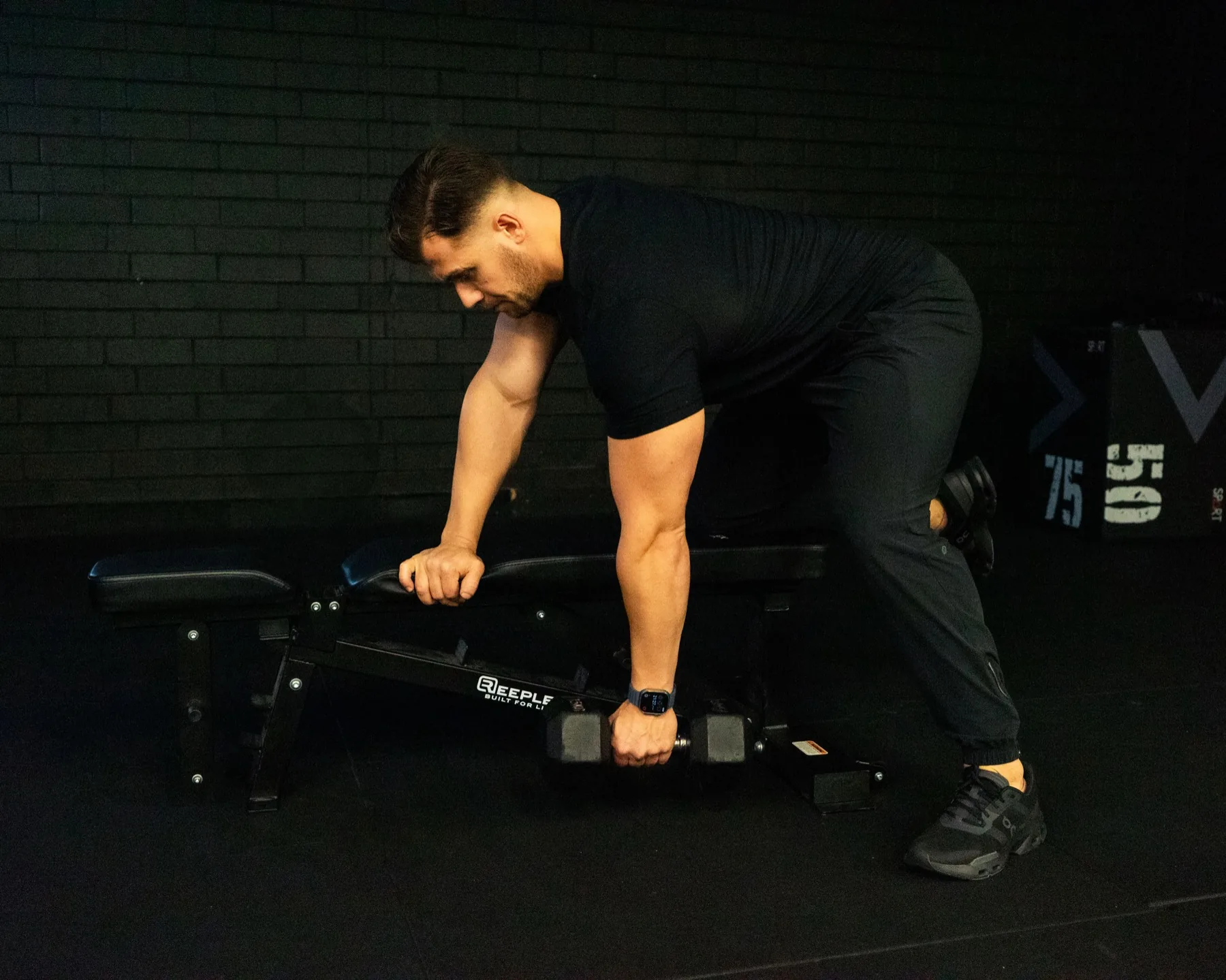 Hudson performing a bench-supported dumbbell row