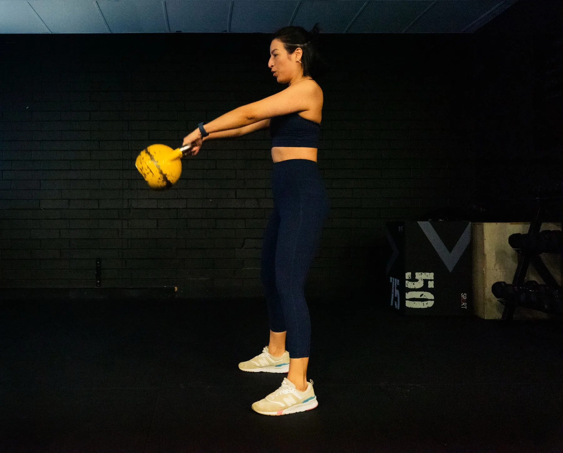 Client practicing kettlebell swing technique