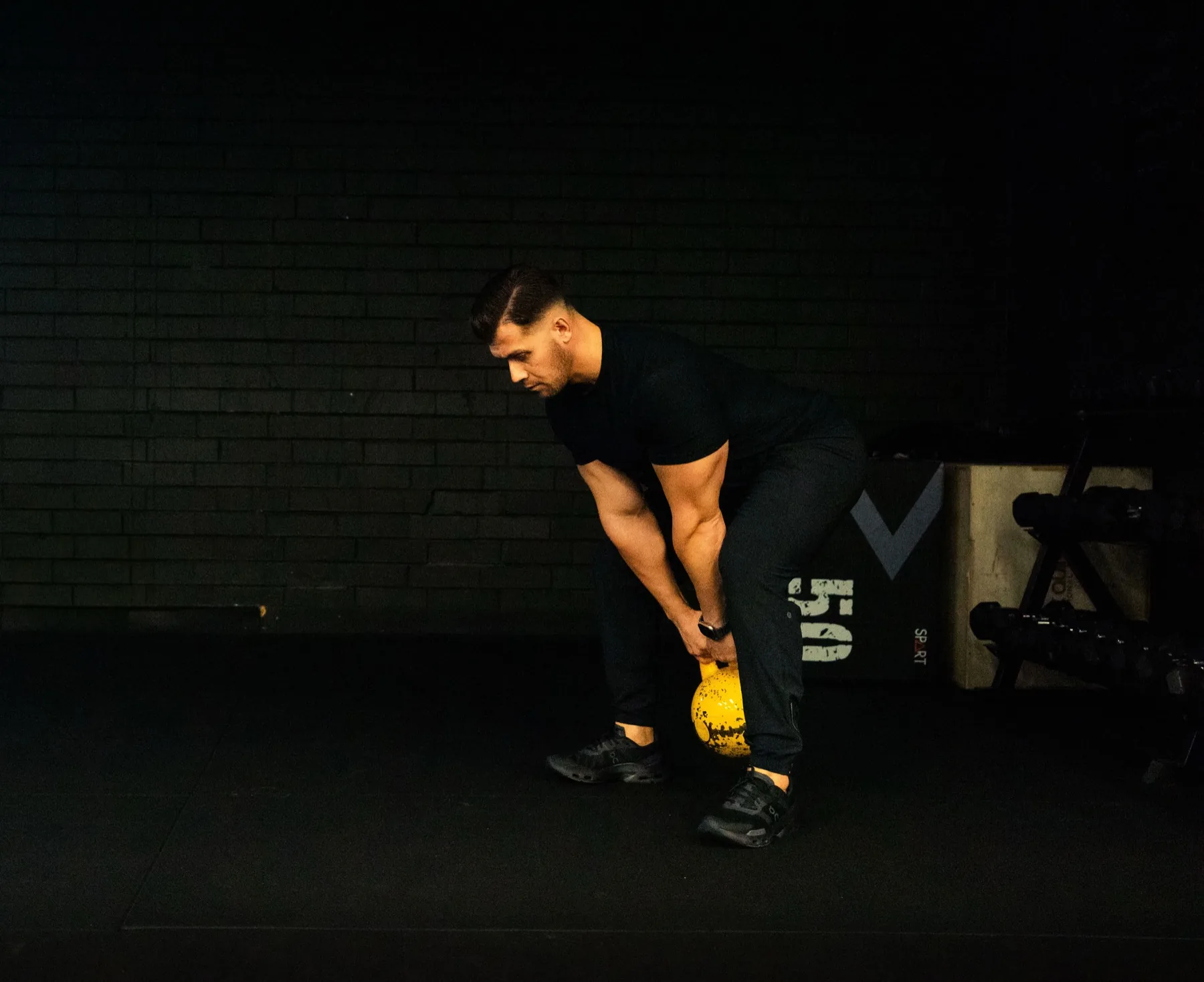 Hudson setting up for a kettlebell deadlift