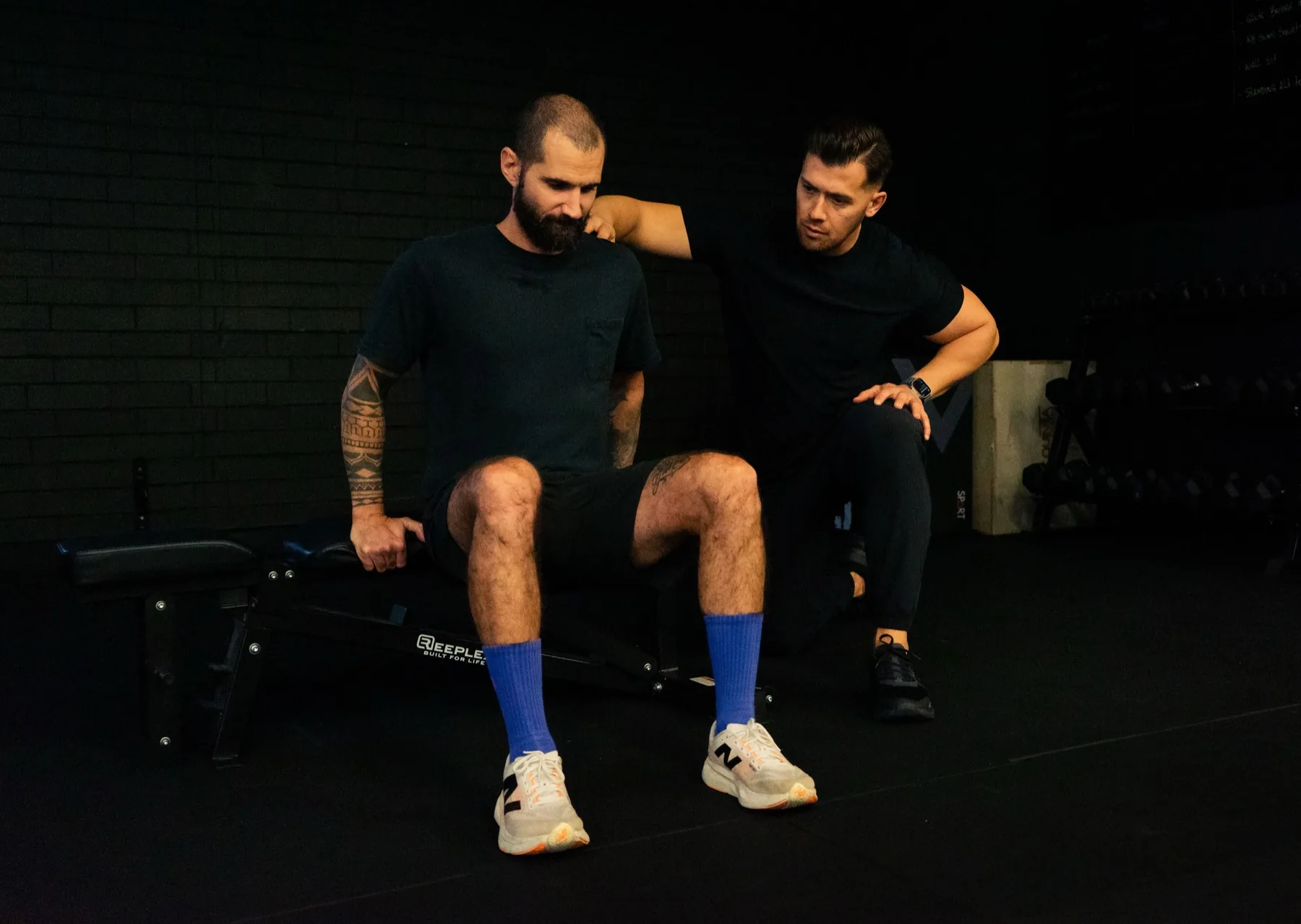 Hudson coaching a seated bench dip progression