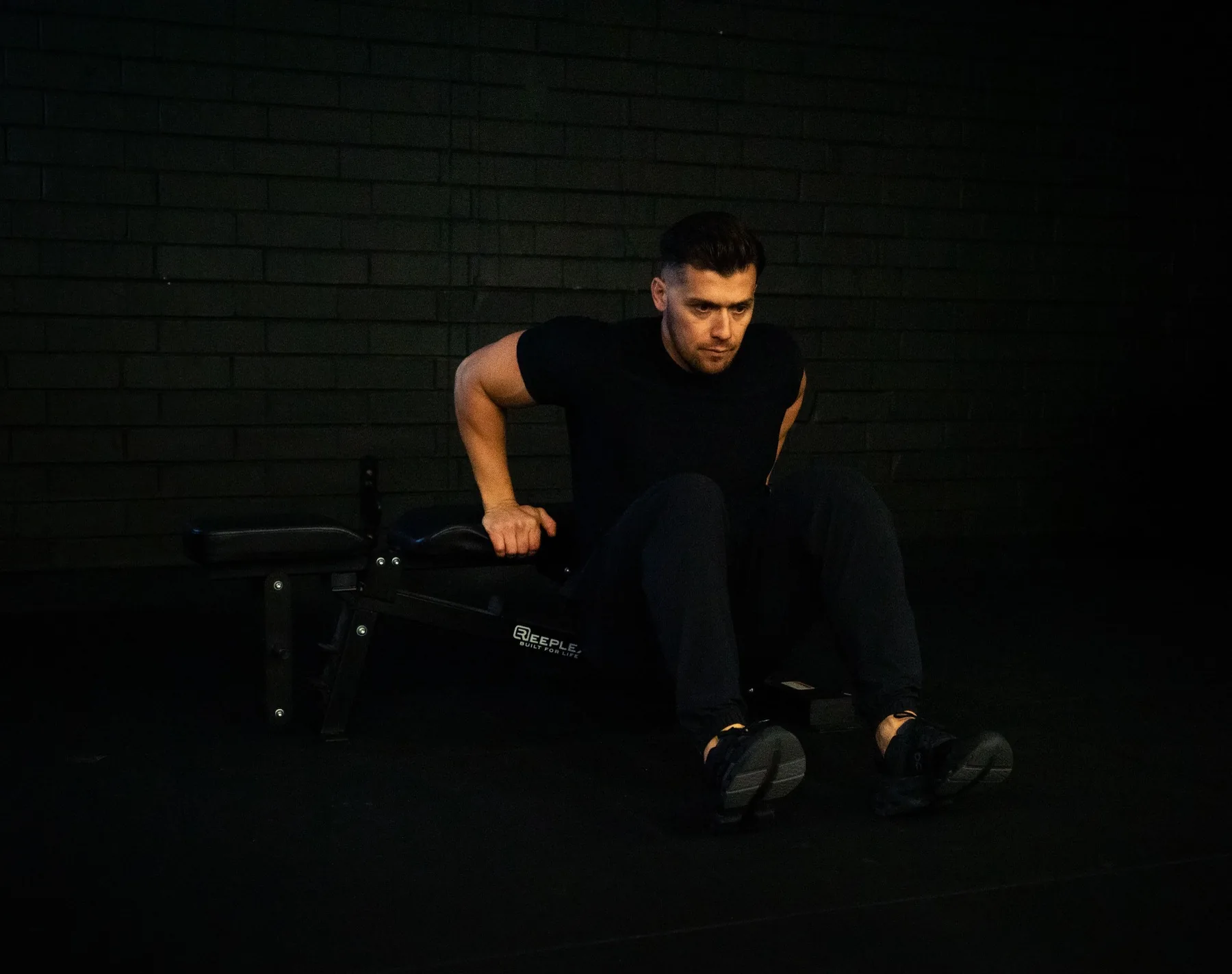 Hudson demonstrating bench-supported tricep dip work