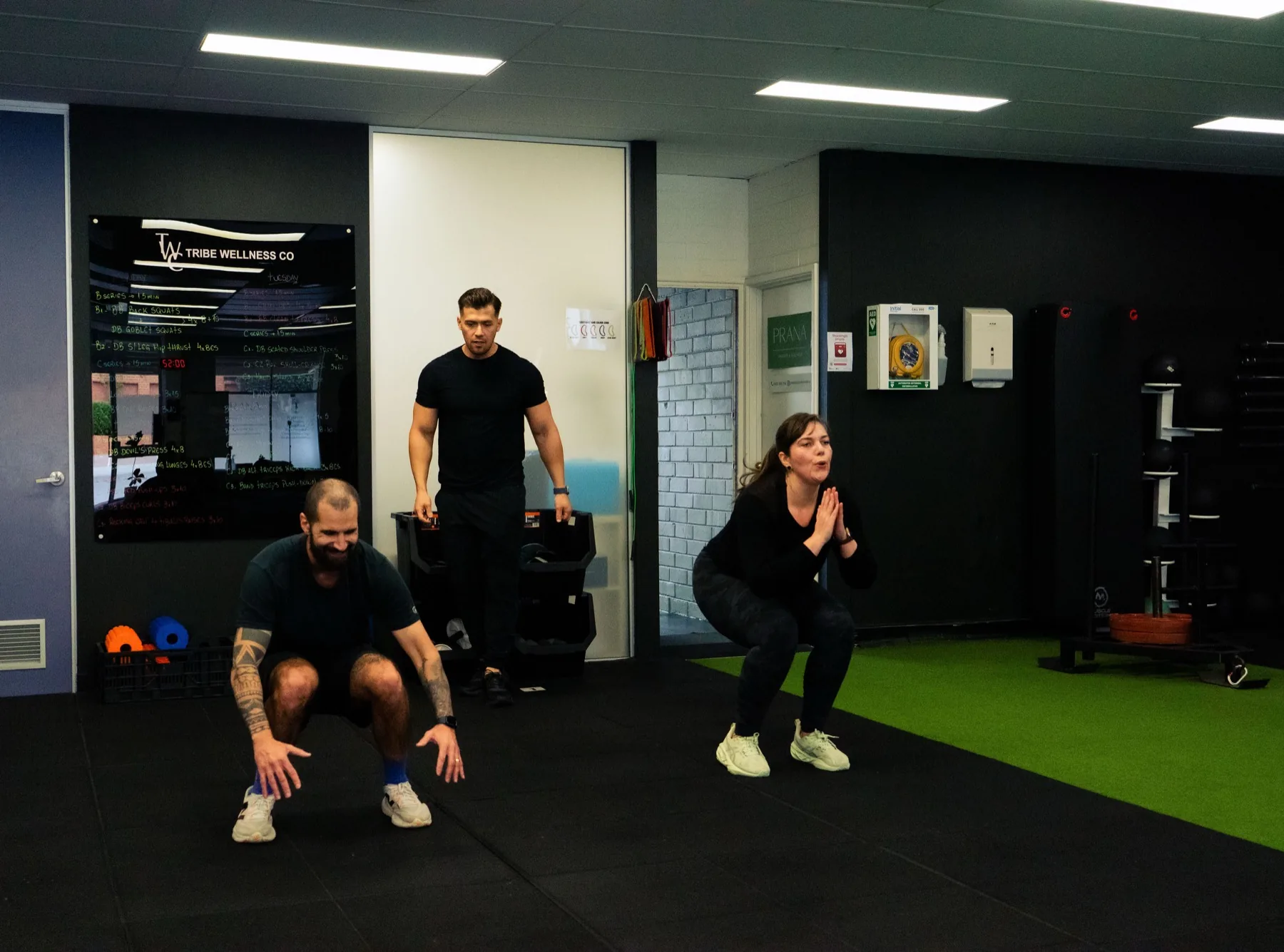 Hudson leading clients through squat training