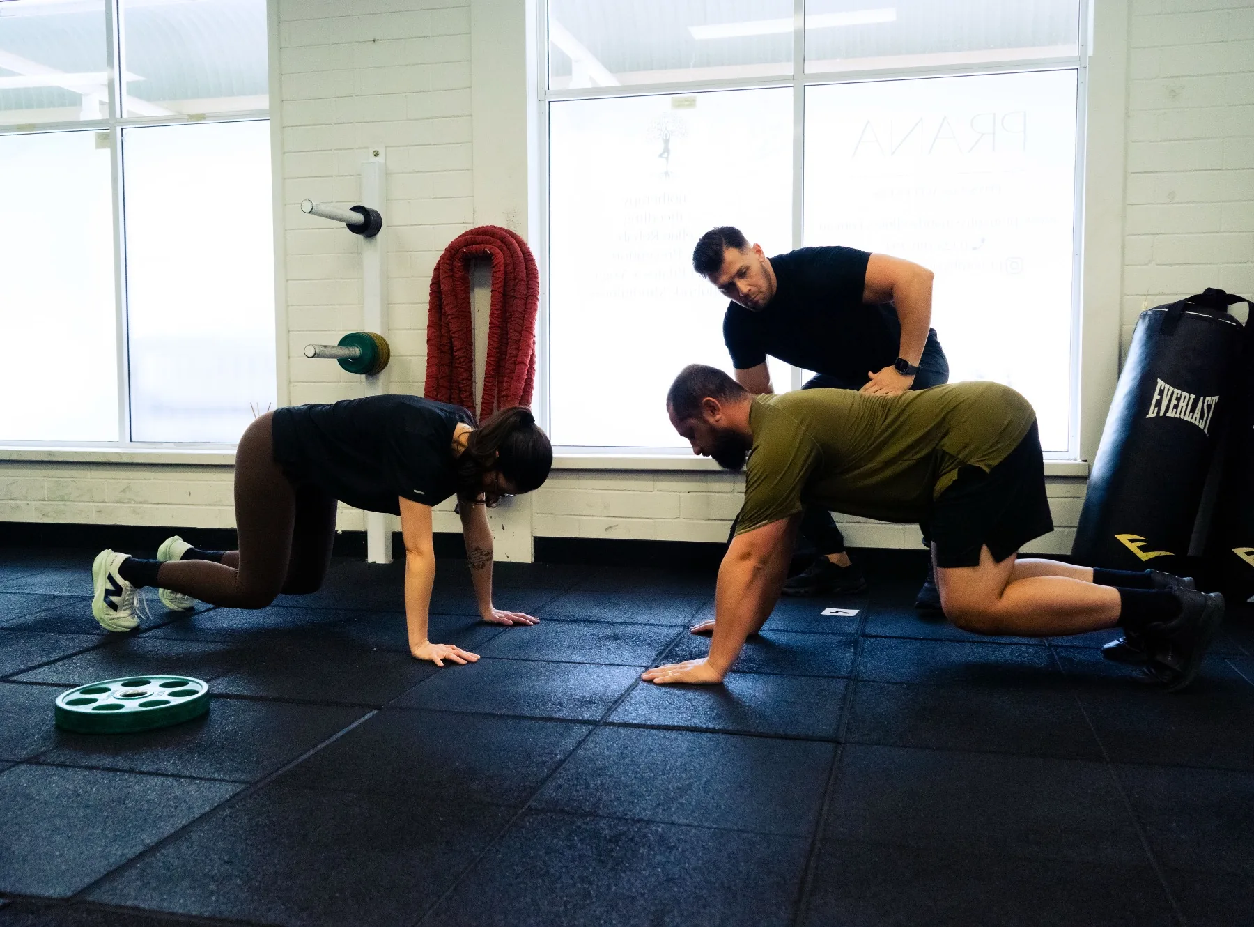 Hudson cueing clients through bear crawl movement