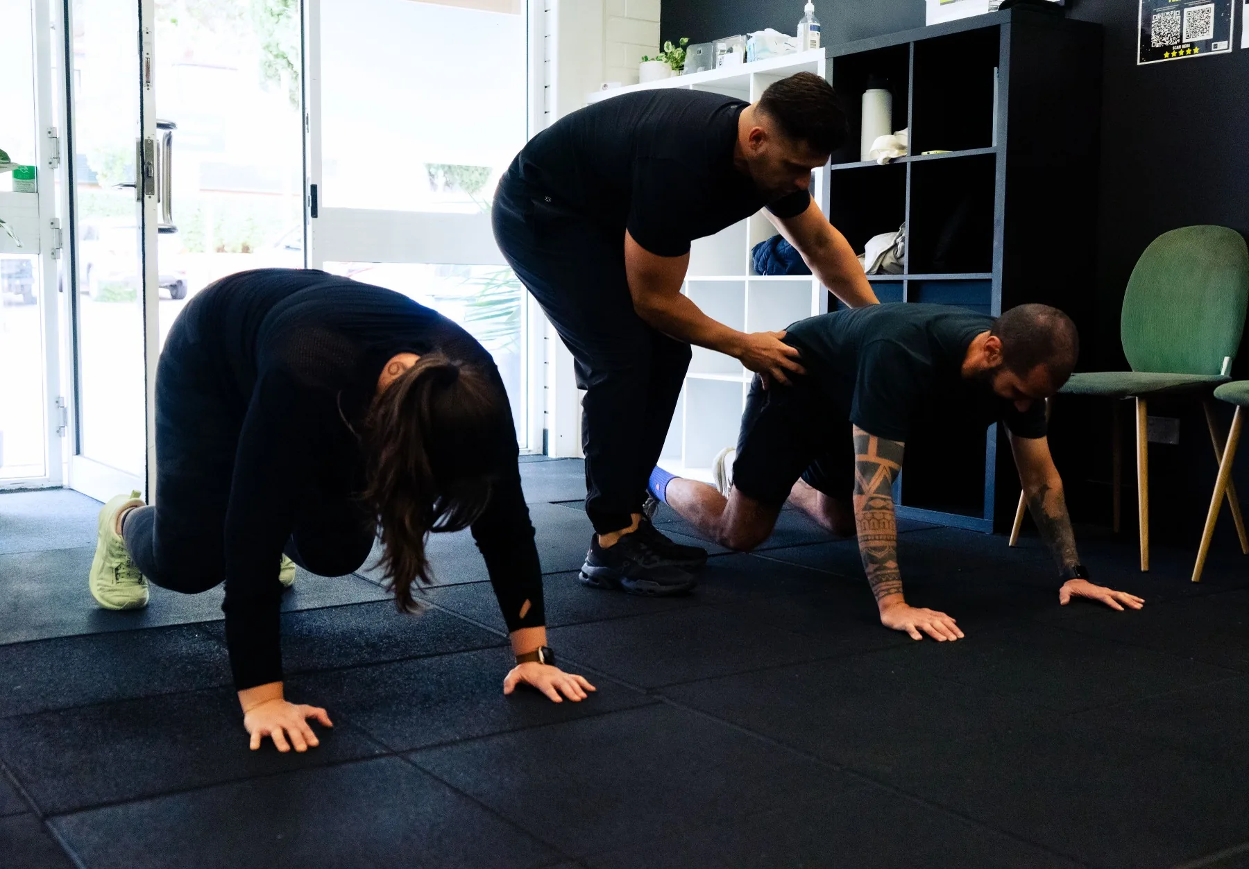 Hudson coaching clients during floor-based conditioning