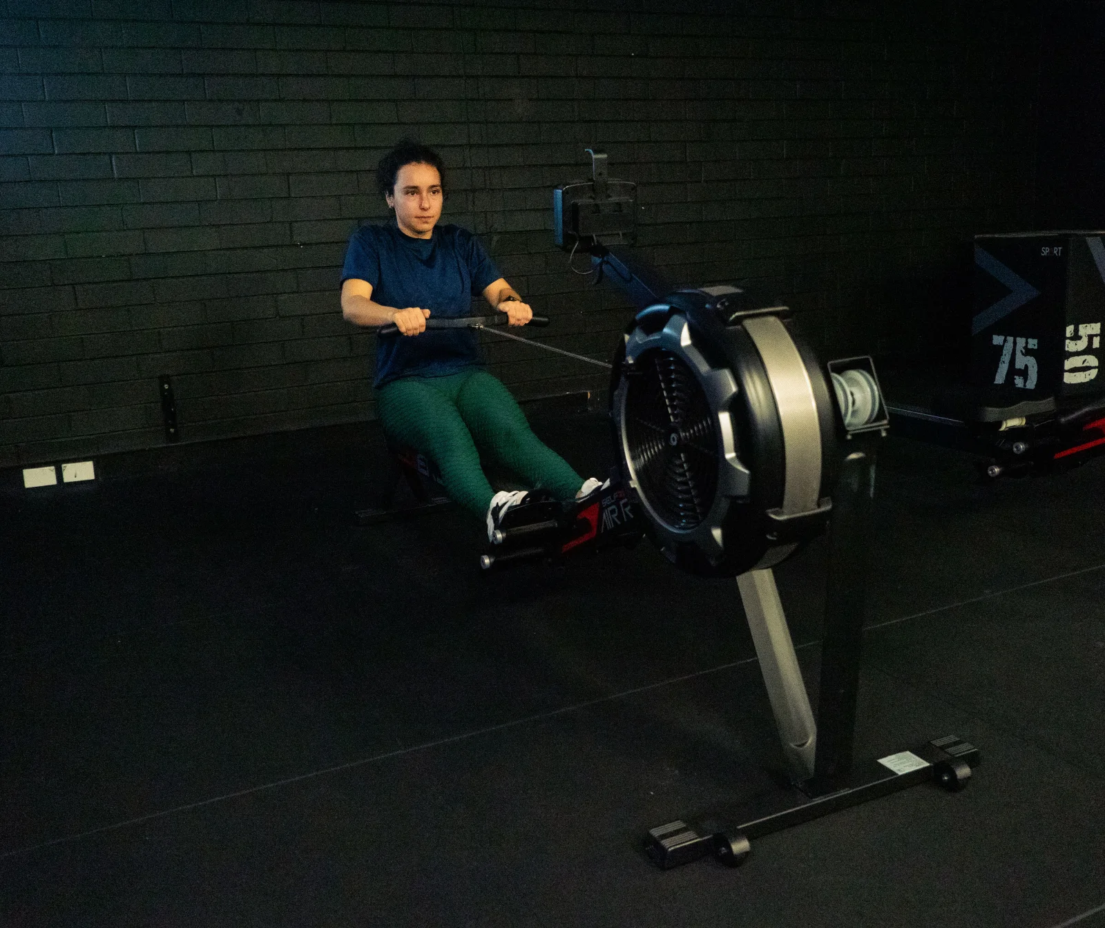 Hudson client rowing in the gym