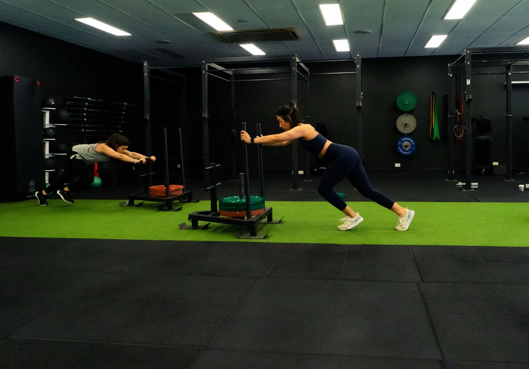 Clients performing fast sled pushes side by side