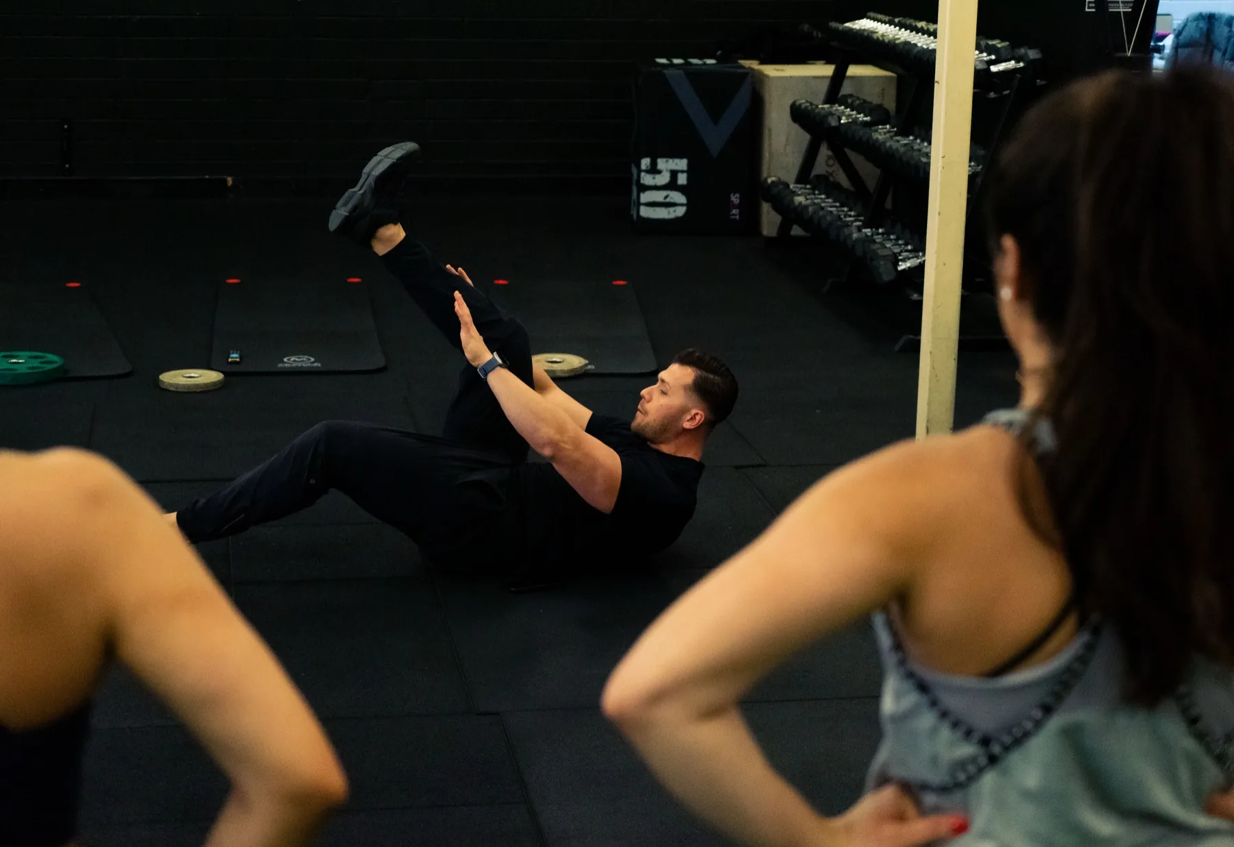Hudson demonstrating a floor core exercise to clients