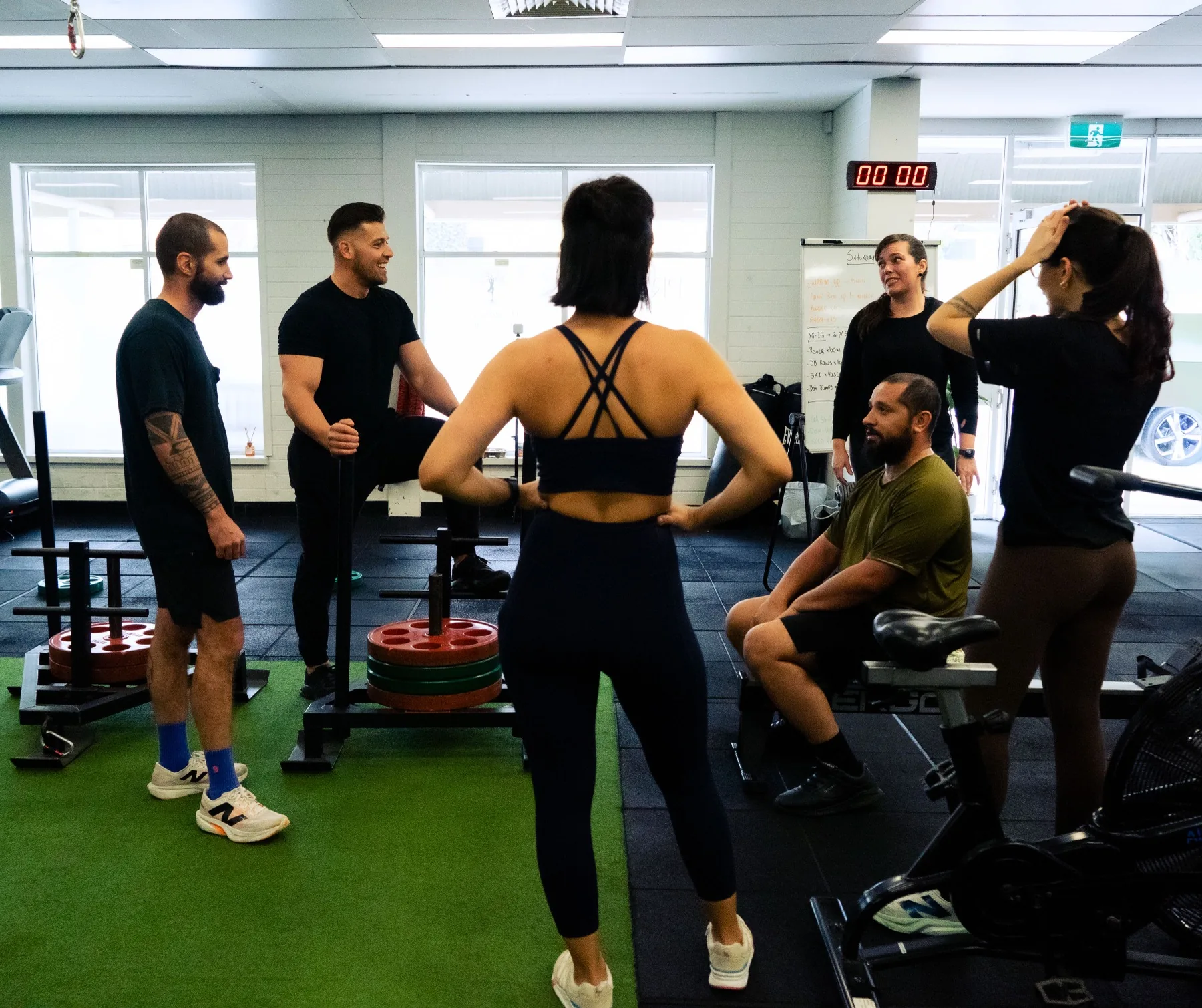 Hudson speaking with clients during a gym coaching session