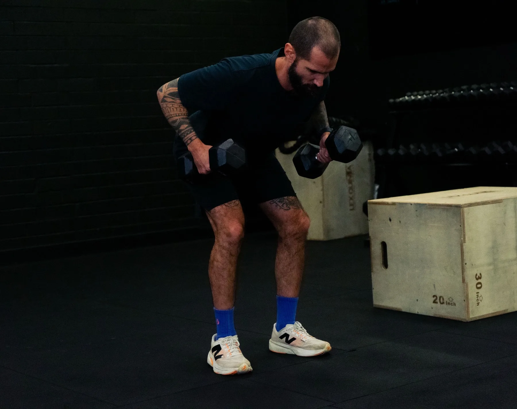 Client performing bent-over dumbbell rows in the gym