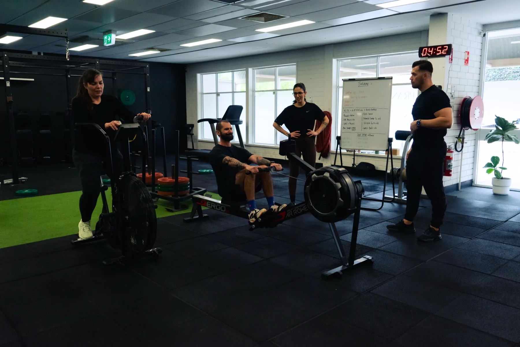 Clients rotating through bike and rowing stations with Hudson