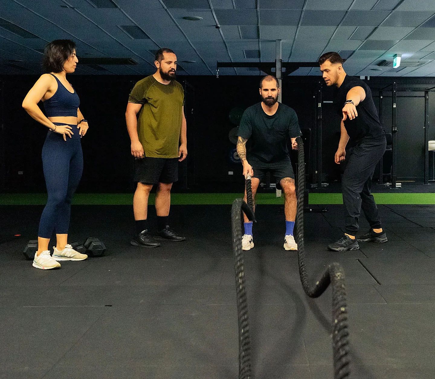 Hudson coaching a small group session in the gym